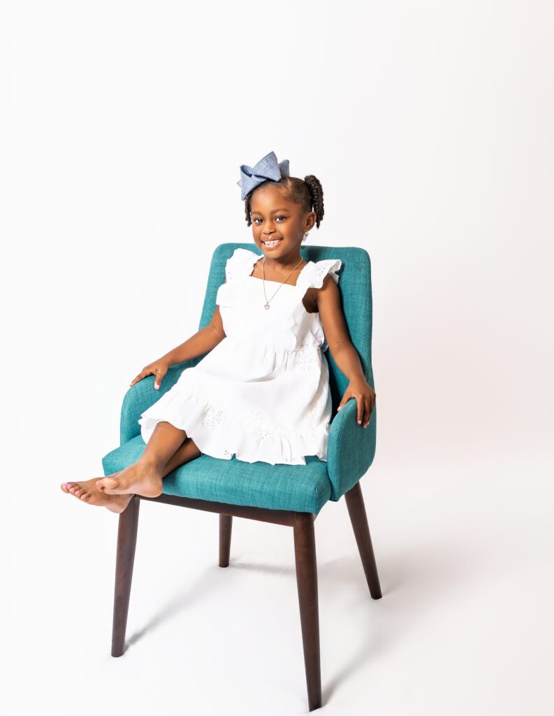 Portrait of Ceyven, a confident young granddaughter, smiling during her generational family portrait session