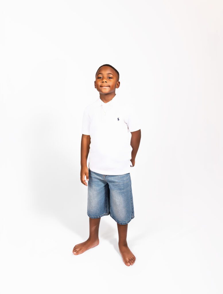 Handsome young grandson posing confidently during a solo moment at the generational family portrait session