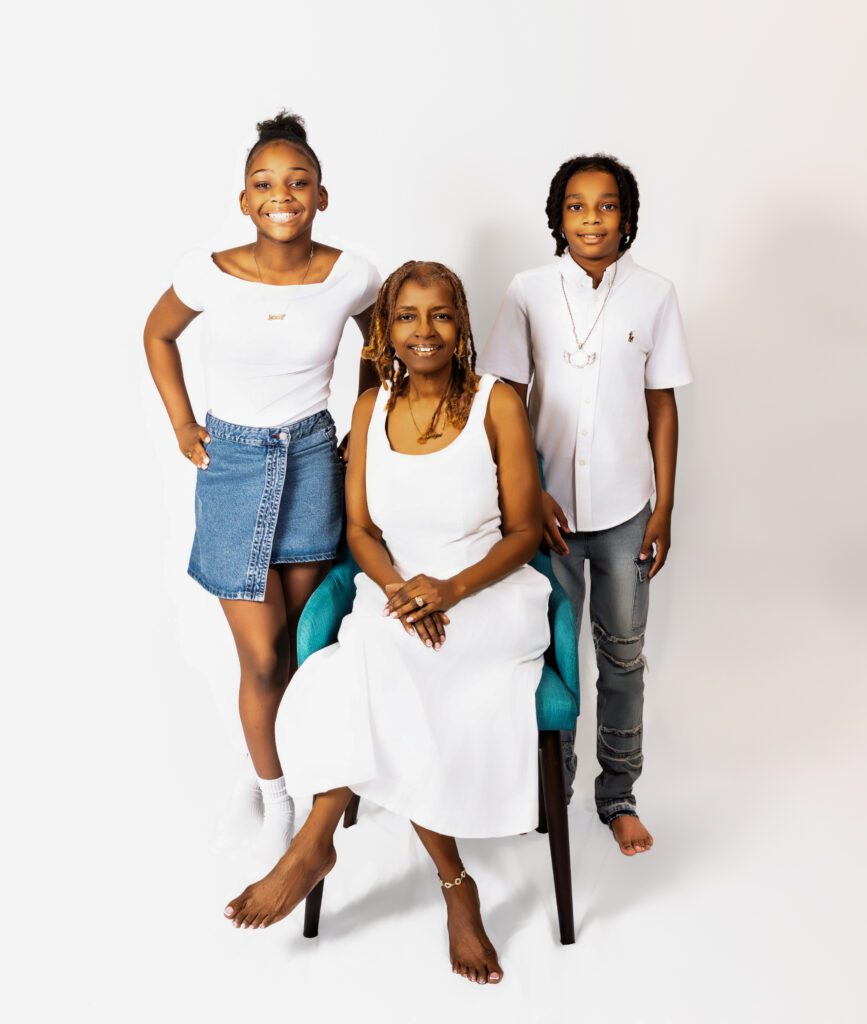 Momo with one grandson and one granddaughter, smiling closely during a family photo session