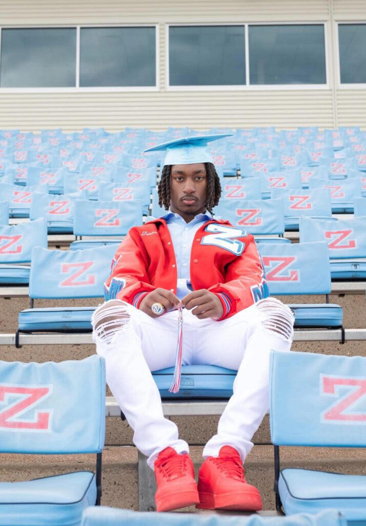 male high school senior posing confidently